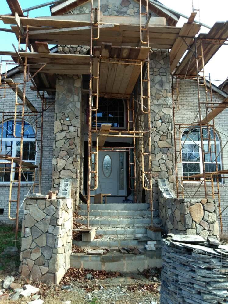 Before of real stone and veneer wrapped entry pillars for residential home